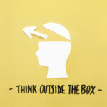open human brain with arrow symbol near think outside box message